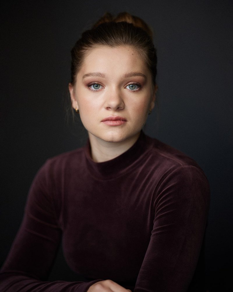 Montreal-actress-headshot-casting-photographer-portrait-black-background-purple-velvet-high-bun-by-nadia-zheng