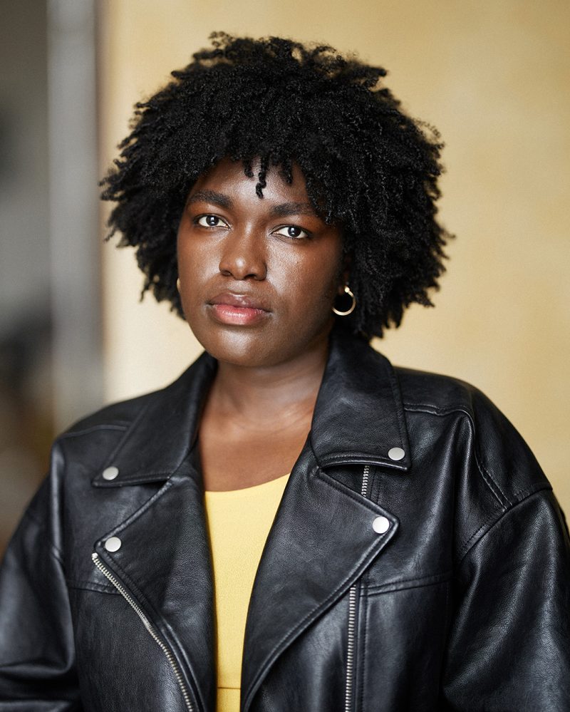 Montreal-actress-headshot-dark-skin-afro-leather-jacket-yellow-top