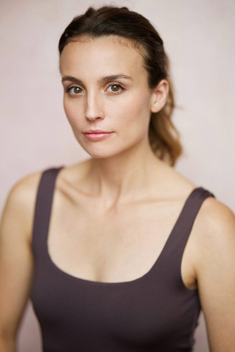 Montreal-actress-headshot-purple-camisole-pink-background