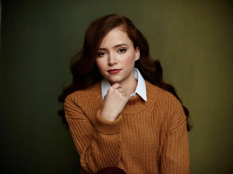 Montreal-actress-headshot-red-hair-orange-sweater-fair-skin-dark-green-handpainted-canvas-backdrop-by-nadia-zheng