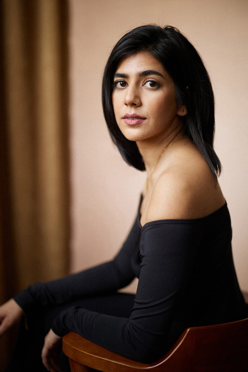 Montreal-actress-headshot-wooden-armchair-off-shoulder-top-by-nadia-zheng