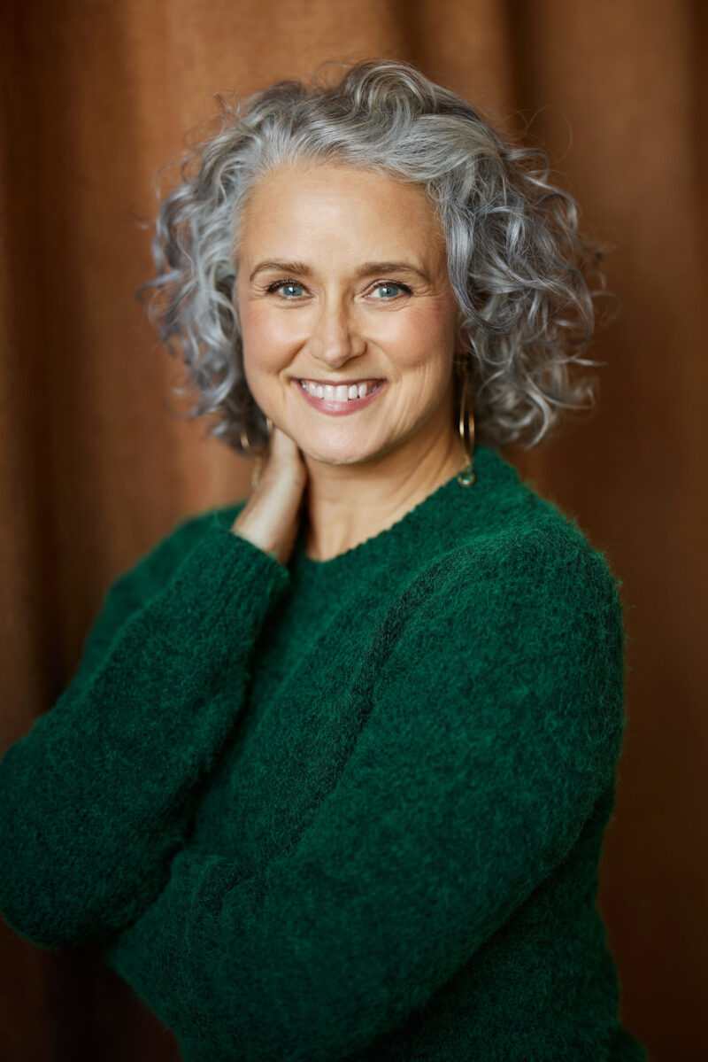 Montreal-artist-headshot-green-sweater-orange-curtain-by-nadia-zheng