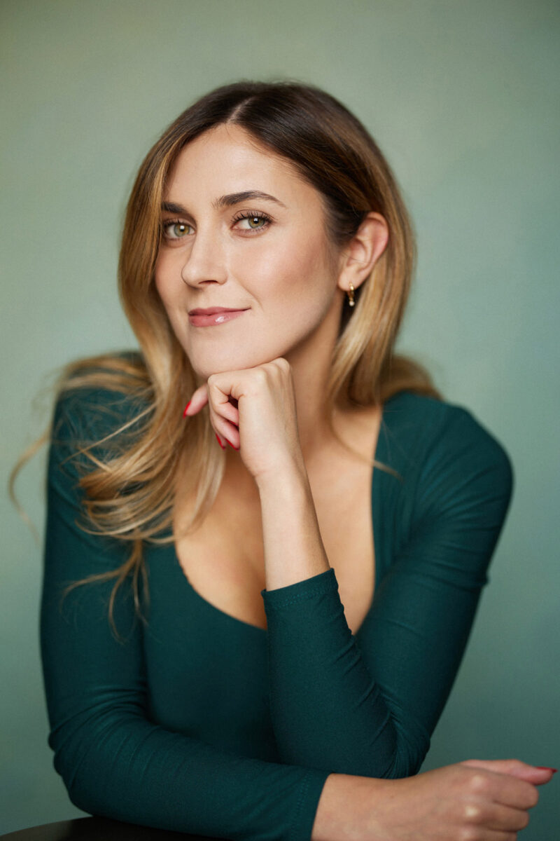 Montreal-Actress-Headshot-blue-eyes-long-hair-green-top-green-background-by-nadia-zheng