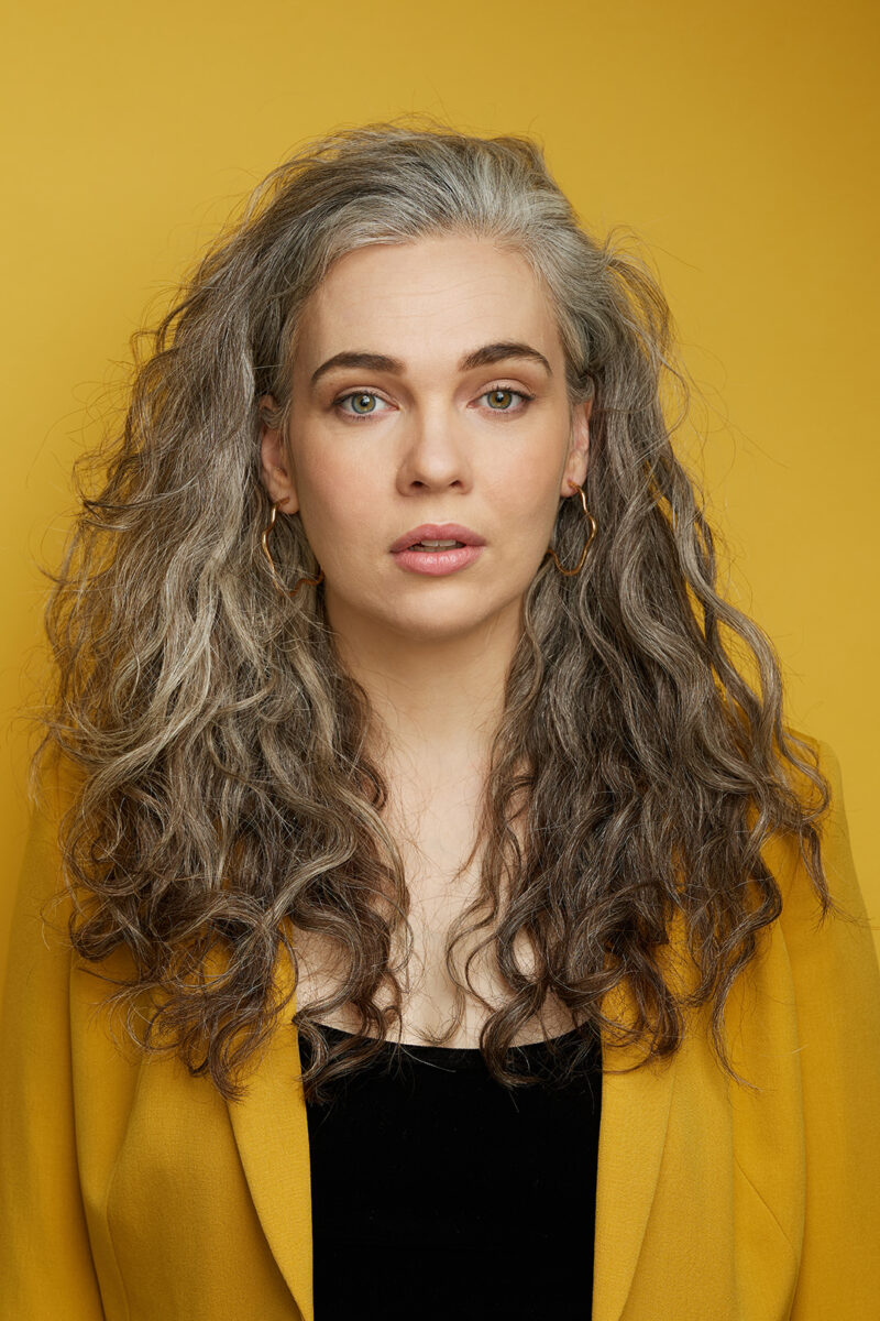 Montreal-artist-headshot-yellow-blazer-yellow-background-monotone-singer-casting-by-nadia-zheng